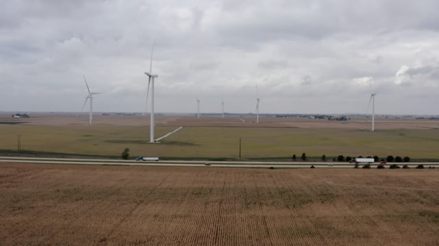 Wind turbines in a farmer's field. Natural crops and rustic rural lifestyle. 