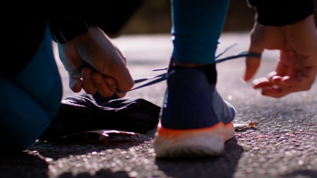 Tying up laces on running shoes. Get ready to move. 