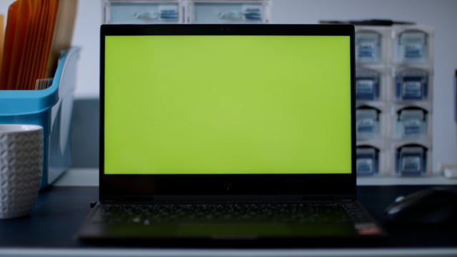 Laptop in a creative workstation. Green Screen and ready for compositing. Perfect for website. Shot in 4k.