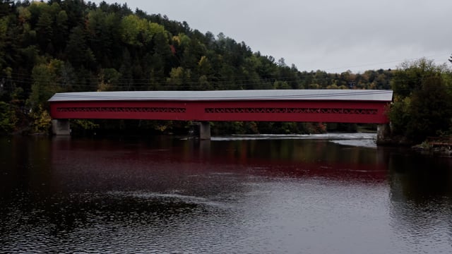 Red bridge over stillwater in northern quebec. 