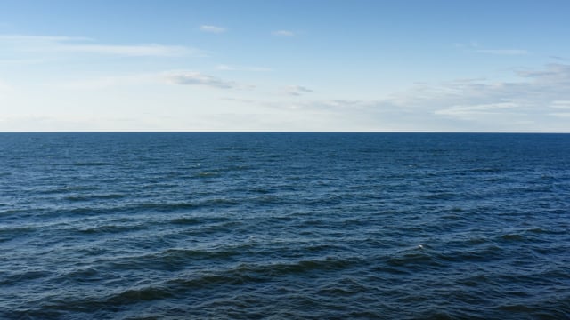 Open great lake. Waves roll over each other as the great expanse recedes over the horizon. 