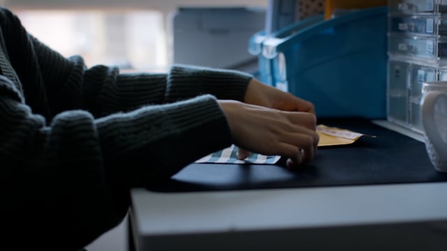 A young business owner packages up her products for her online customers.  