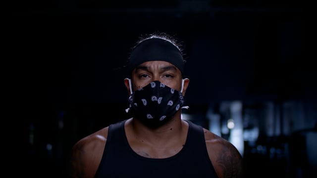 Mask at the gym! Strong and powerful portrait of a diverse athlete. Focused on achieving his goals.