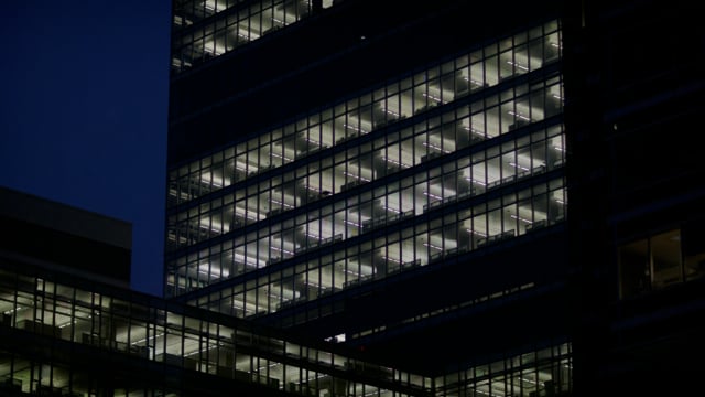 Office building with lights in windows late at night. Ideal for establishing shots. 