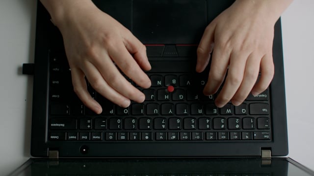 Typing on a laptop keyboard. Closeup of a typing process on a computer. 