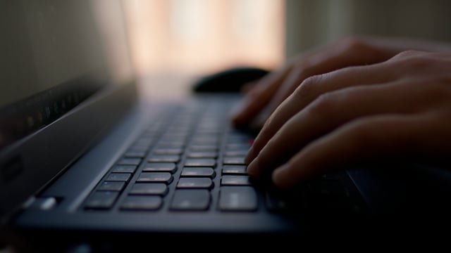 Woman typing a message on a laptop. Closeup of a typing process on a laptop.