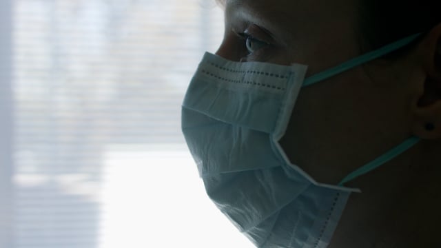 Wearing a medical mask during a covid-19 pandemic by a nurse. Wearing a protective face mask. 