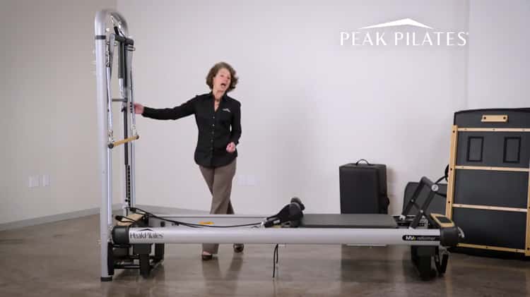 Peak Pilates - Pilates Trainer Exercising on Peak Pilates Reformer