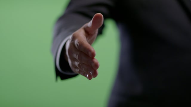 Handshake from Businessman on green screen.