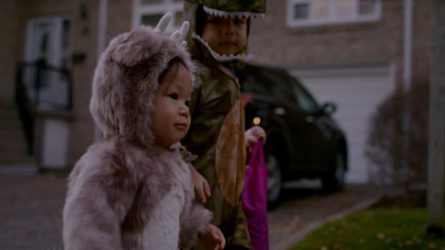 Adorable baby trick or treating with family in the neighbourhood for Halloween. 
