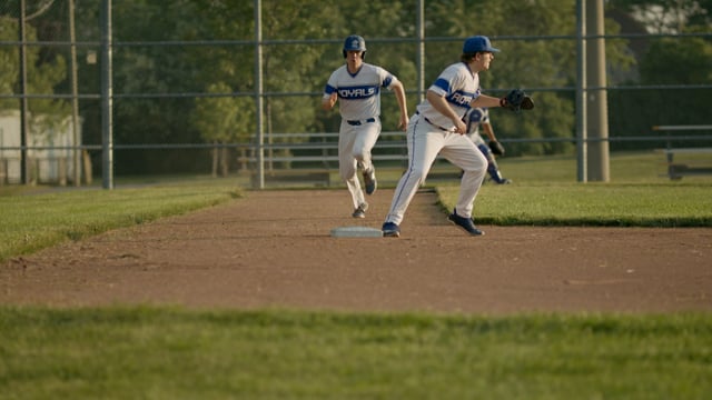 Close call! Running to the plate a baseball player touches the bag on a close call. Athletes and competition in action. 