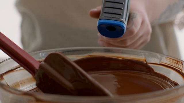 Melted chocolate being stirred. 