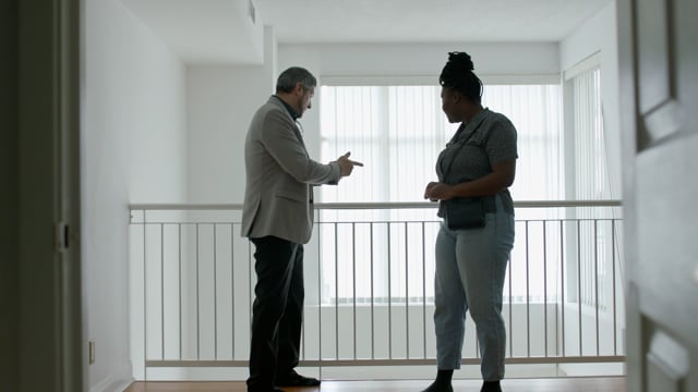 A savvy real estate agent shows a young black woman around a potential home that's just come on the market. 