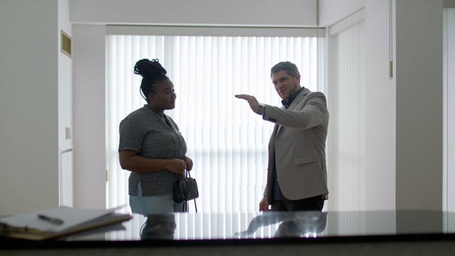 A savvy real estate agent shows a young black woman around a potential home that's just come on the market. 