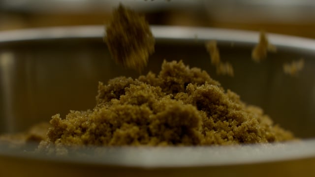 Rich and sweet. Brown sugar tumbles into the mixing bowl. 