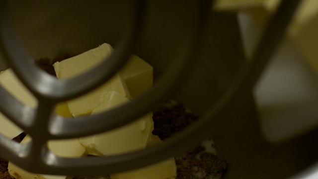 Sticks of butter are tossed into the industrial mixer as the baking ingredients come together. 