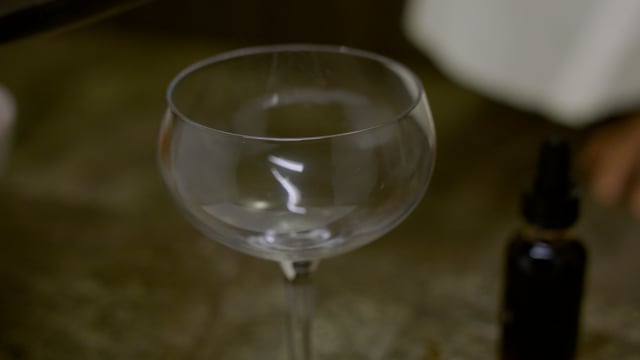 A perfectly executed cocktail is poured into a beautiful coupe glass.