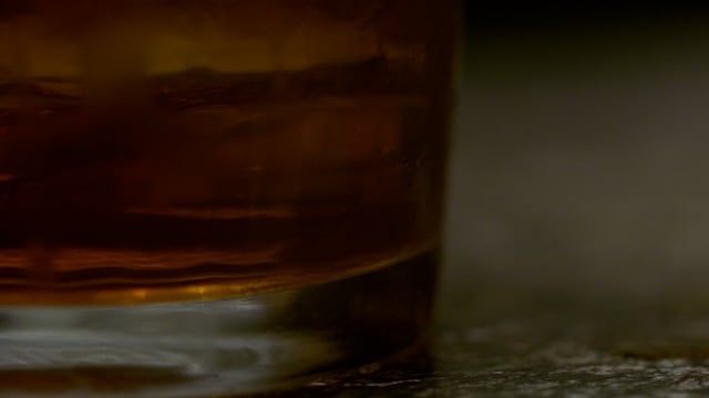 Macro shot of a cocktail being stirred. 