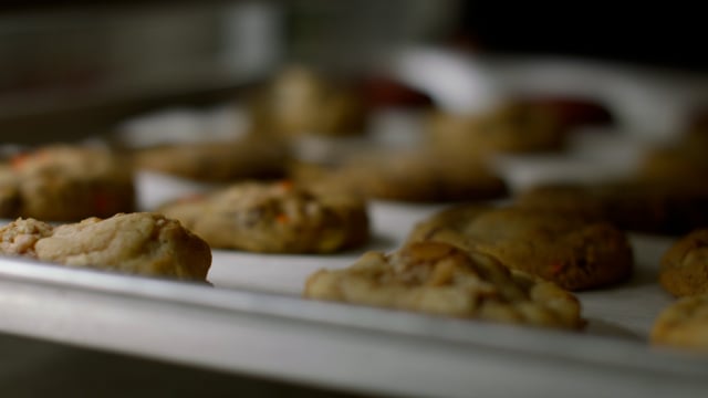 A hot and fresh tray of delicious cookies are out of the oven and cooling on the rack. 