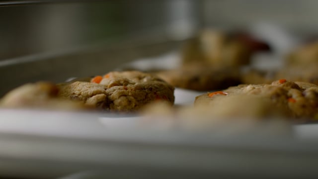 A hot and fresh tray of delicious cookies are out of the oven and cooling on the rack. 