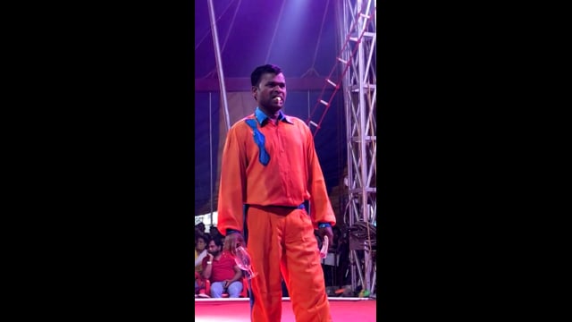 A goldfish is swallowed and regurgitated by a circus performer, Rambo Circus, Pune, India, 2021 (mobile phone footage)