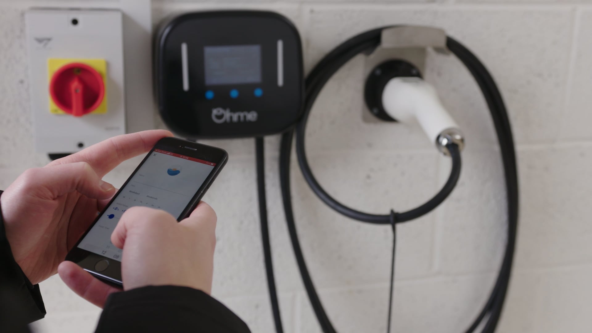 Person setting up an Ohme home electric car charger