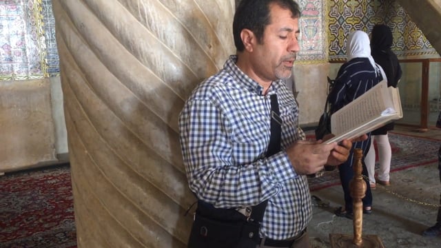 Man reading from book