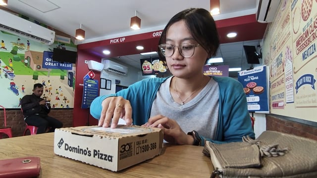 Woman eating pizza