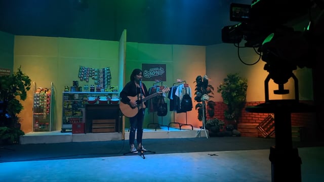Girl with guitar on production set