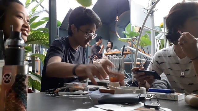 Playing on phone in cafe
