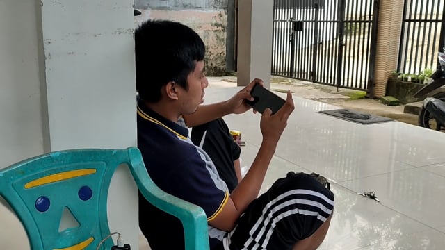 Guy playing on phone
