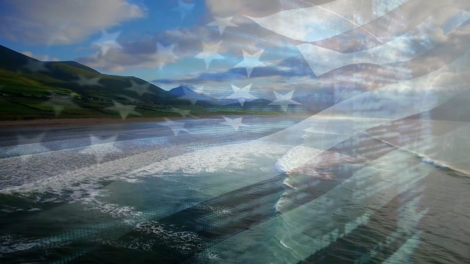 Composite video of waving american flag against aerial view of beach