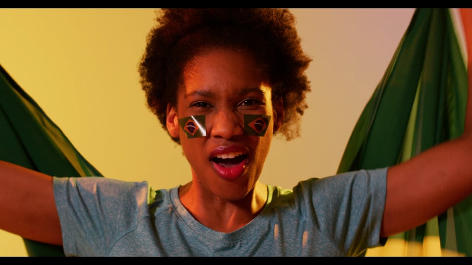 Video of joyful african american female sport fan with flags of