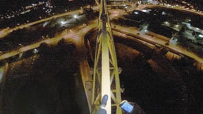 Just balancing on crane at night with flashlight.