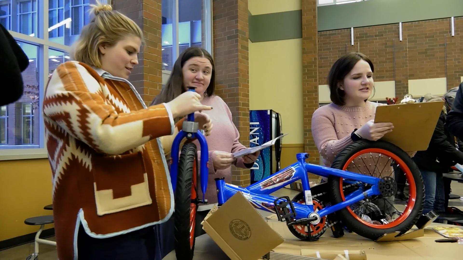 Building community: Rogers staff build, gift bikes to neighborhood kids