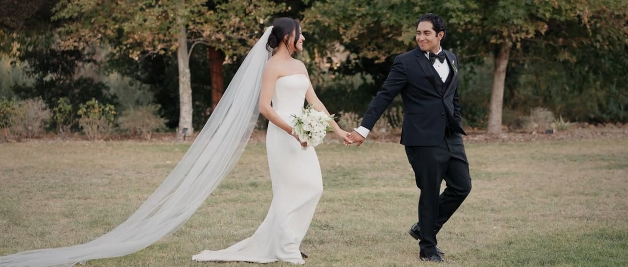 Haruna and Jonathan holding hands outdoors at The Lodge at Malibou Lake