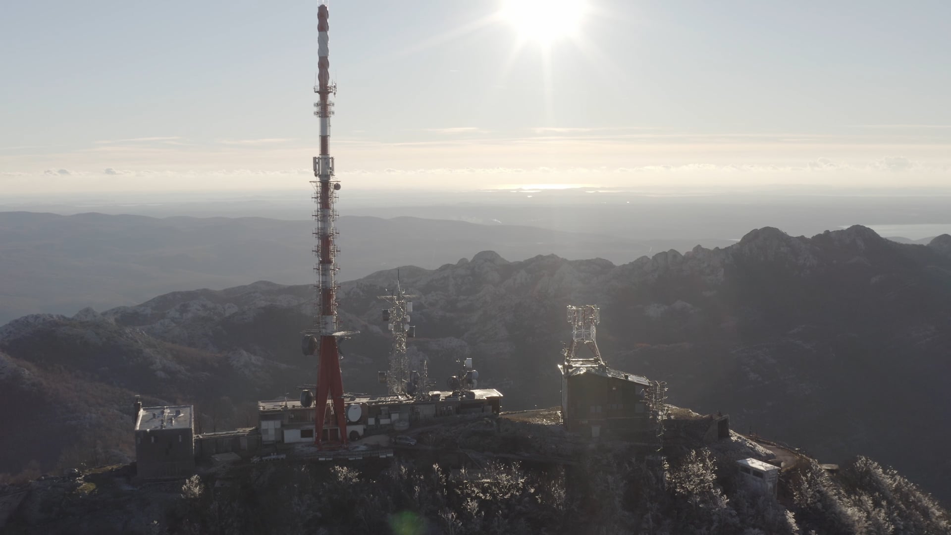 Approaching the antenna on the top of the mountain, sunshine, sea visible far away
