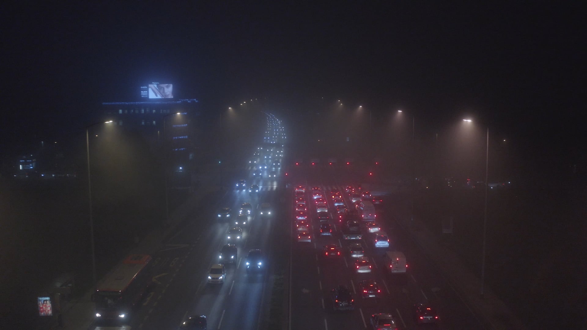 Traffic on avenue, hazy, red light