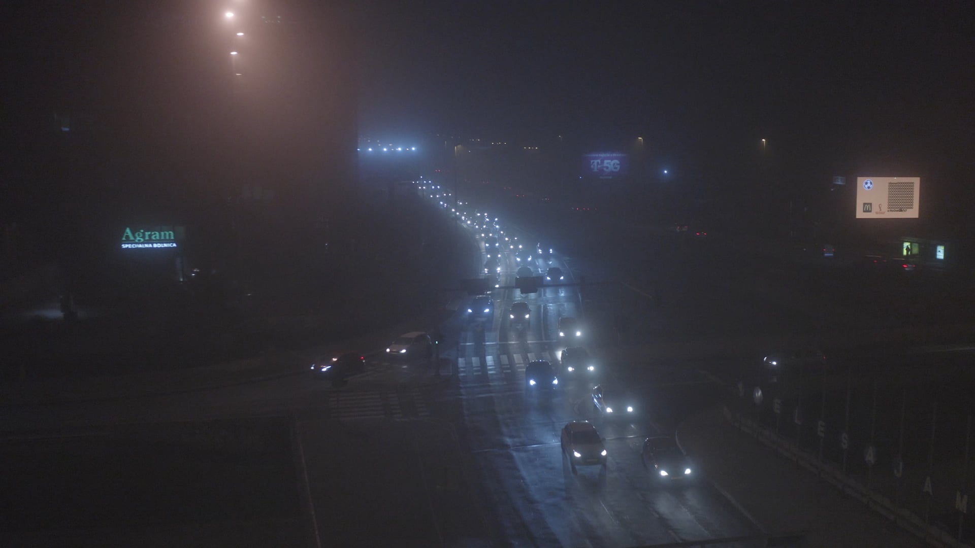 Night traffic in Zagreb, hazy shot with ads along the highway