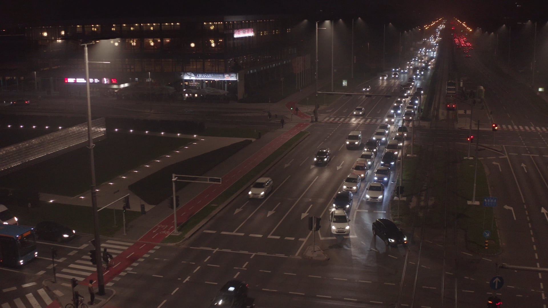 Night traffic, people entering and going out of the tram, tram leaving the station