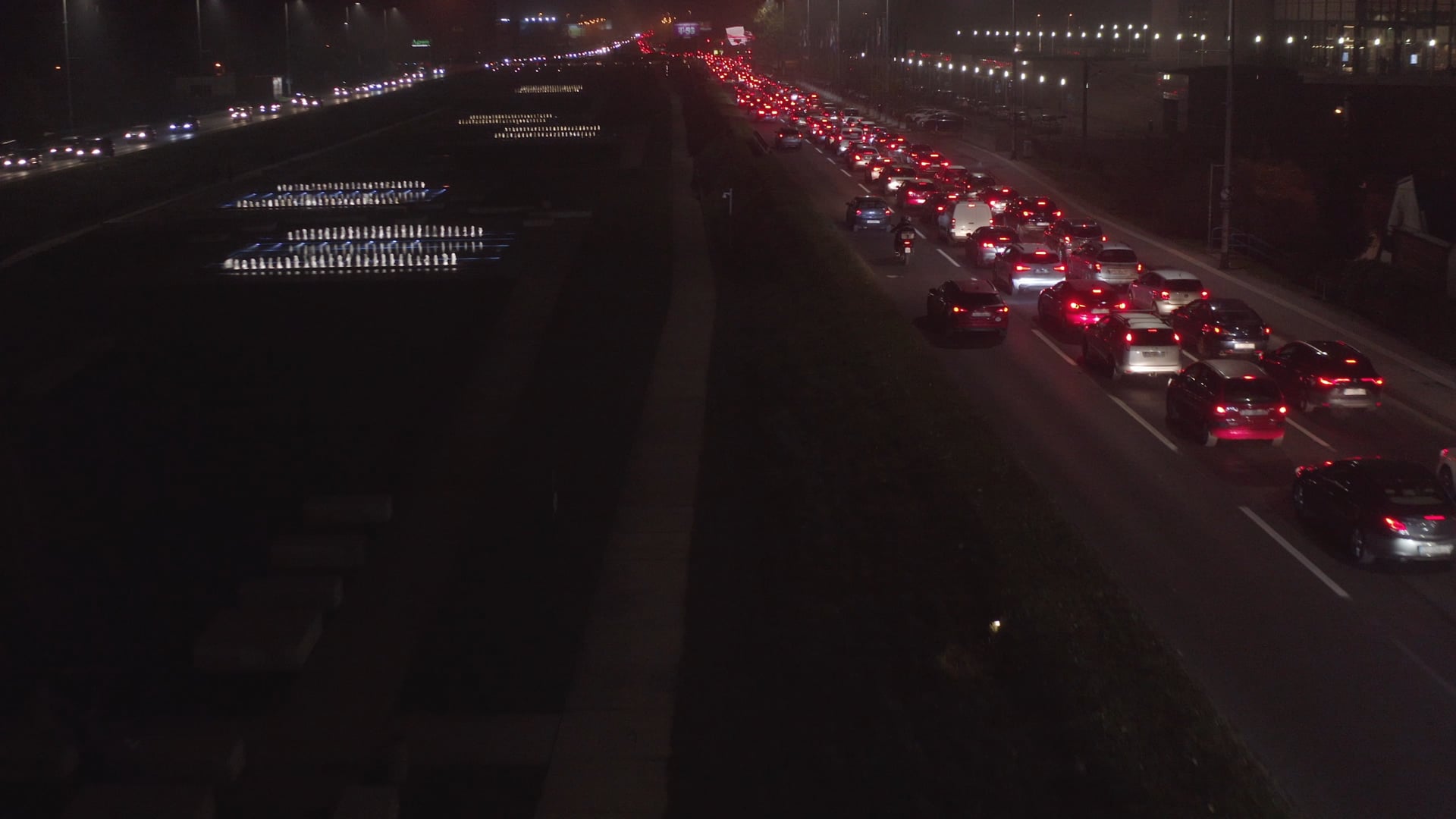 Night traffic in Zagreb, traffic jam on the highway next to the fountains, slowly approaching and moving the cars
