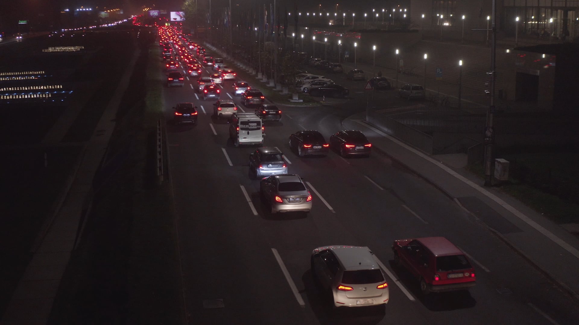 Night traffic, cars stuck in a traffic jam, one car taking the exit on the right