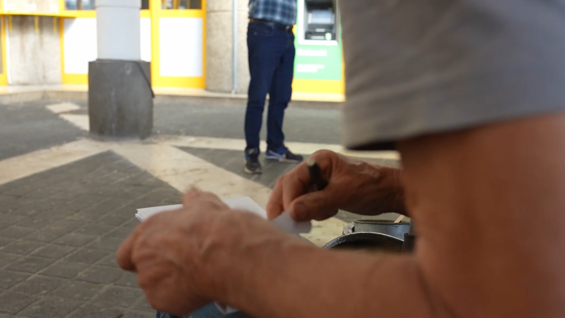 Older man finishing a quick pencil sketch and starting a new one