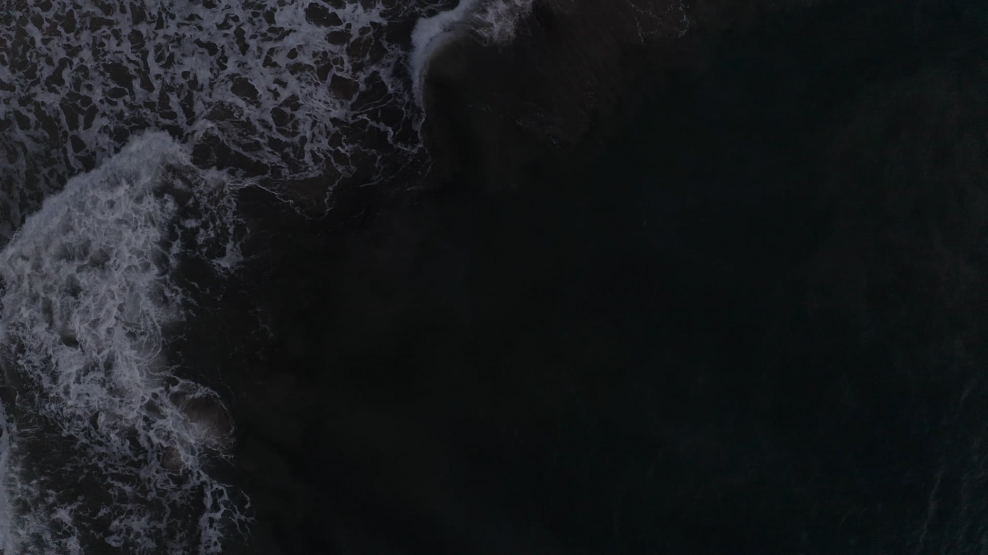 Rotating above waves formed in the sea, foamy dark blue sea