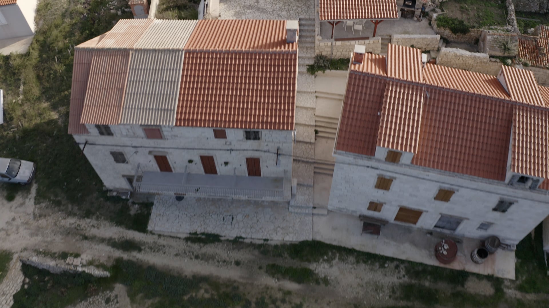 Top view, small orange boat in the crystal clear sea, small beach, old stone houses