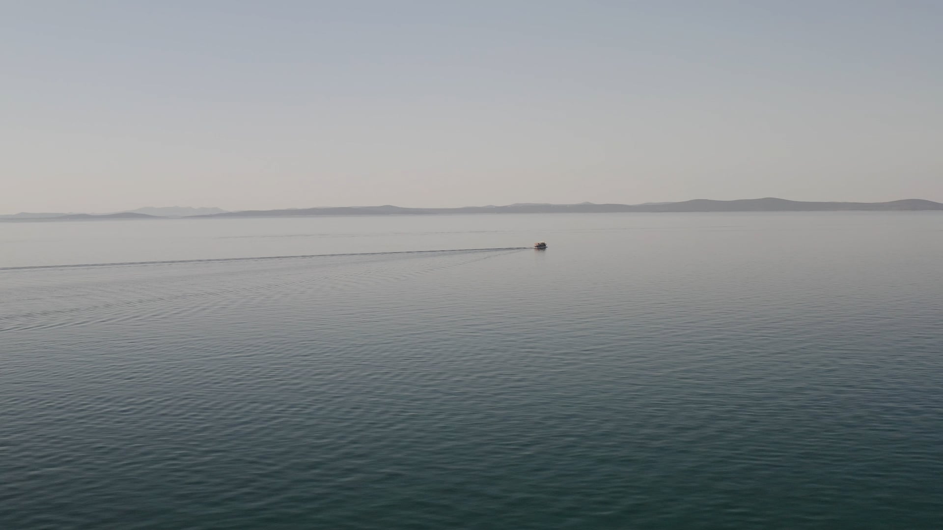 Boat slowly sailing in the beautiful open blue sea