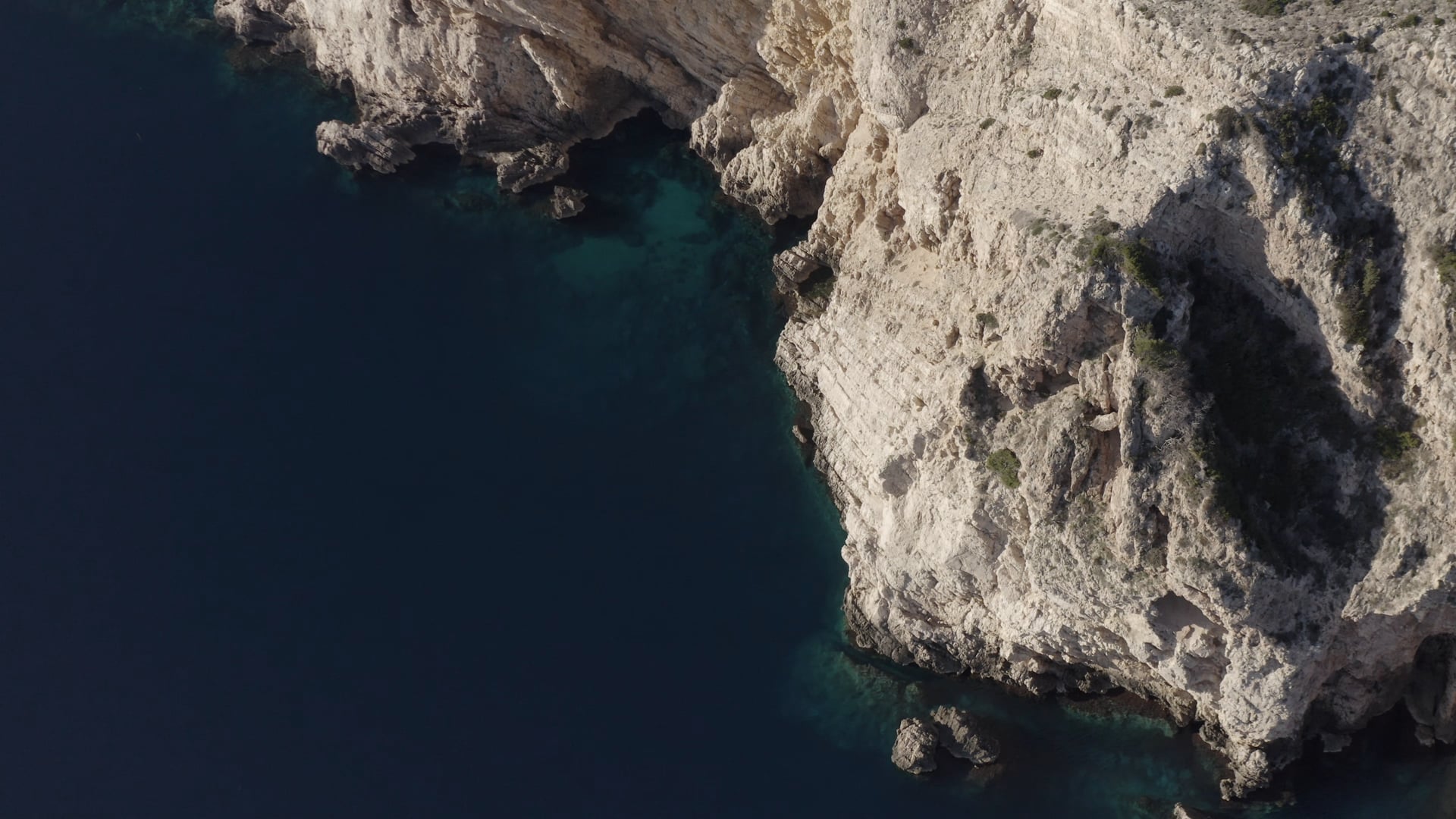 Slowly moving by the deep blue sea near the cliff