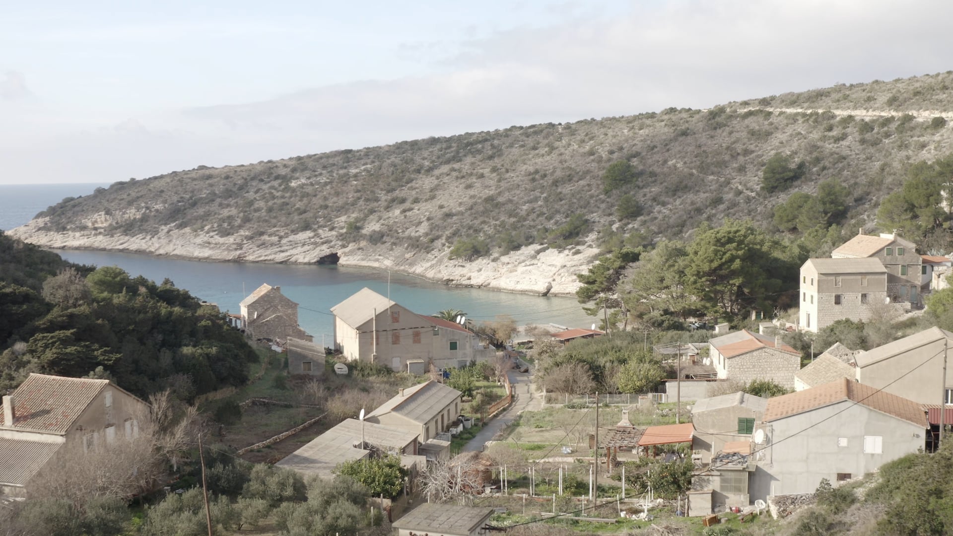 Few stone houses in the small bay, crystal blue sea