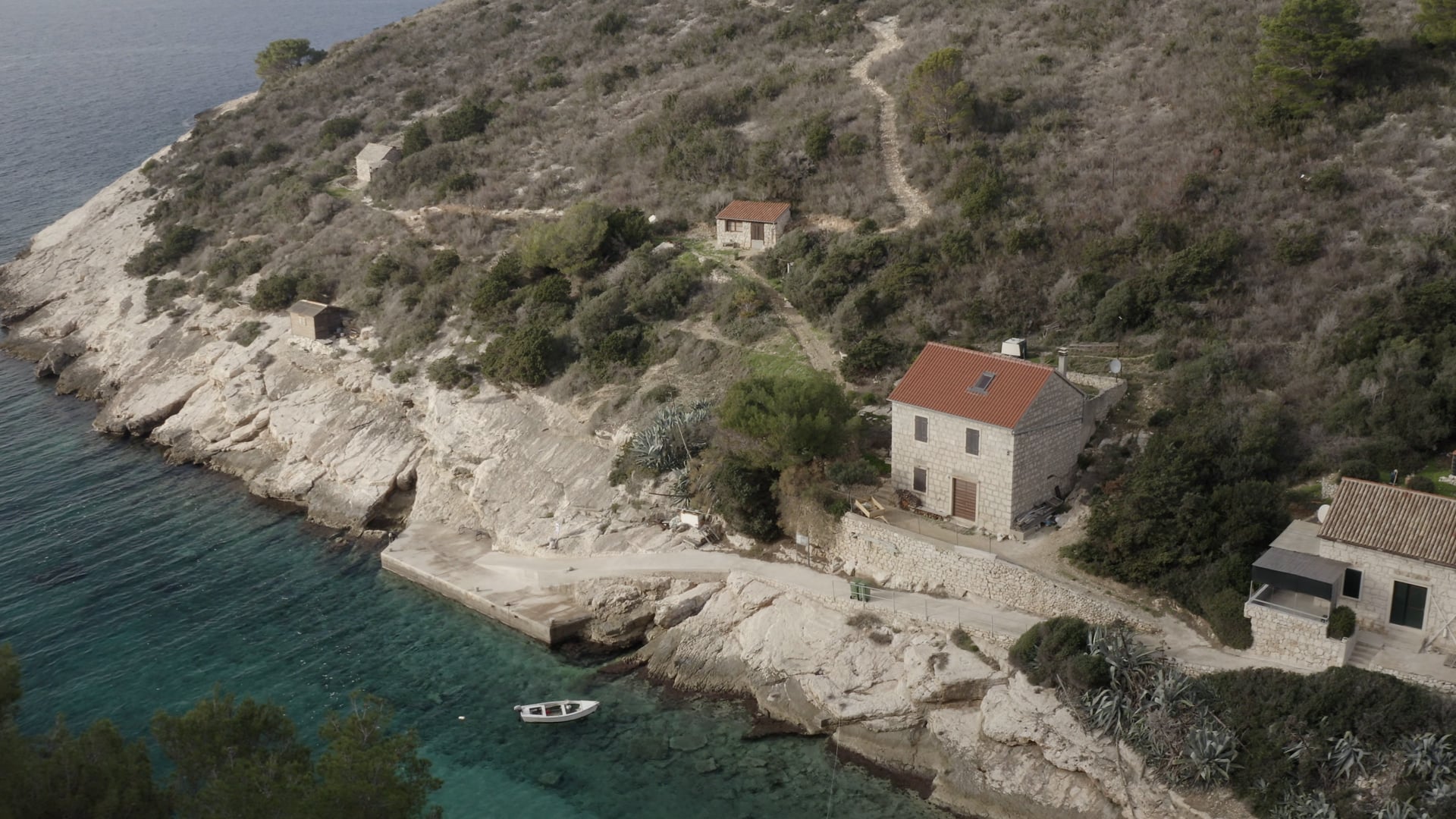 Approaching the small boat in the bay near the stone house