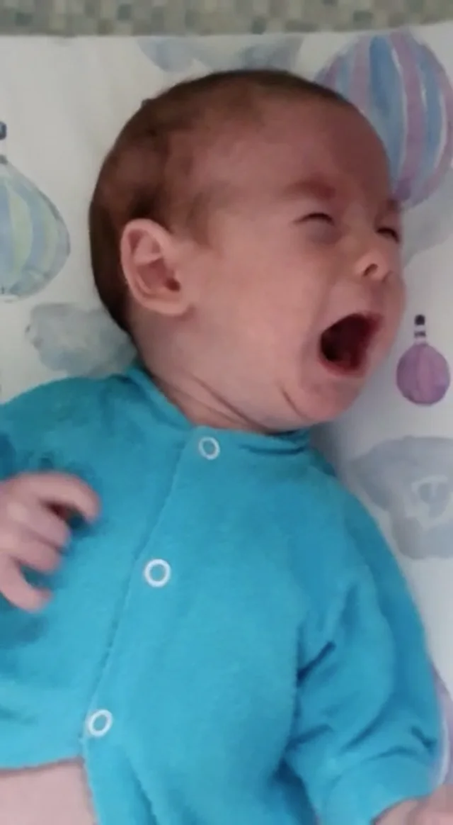 A baby cries after opening a book (funny) on Make a GIF